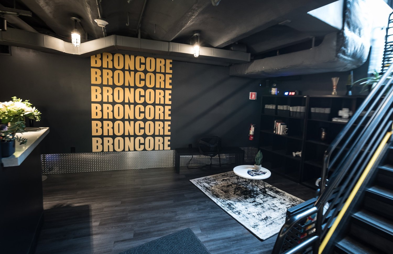 The BronCore Fitness lounge with the BRONCORE branded wall