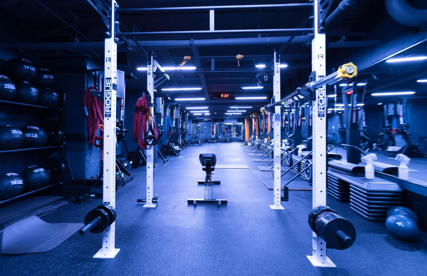 The main training floor at BronCore Fitness with squat racks, turf and conditioning equipment